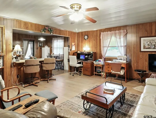 a room with furniture a large window and a chandelier
