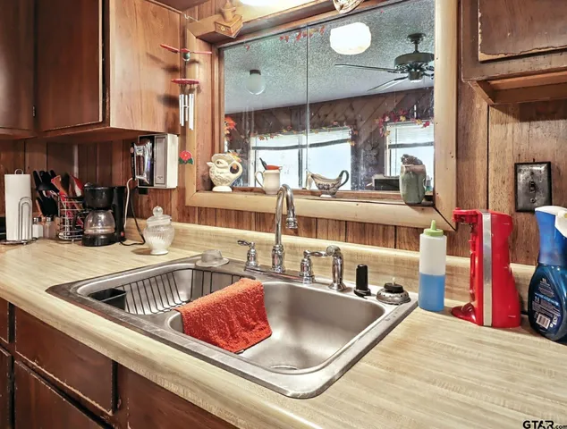 a kitchen with a sink and a stove top oven