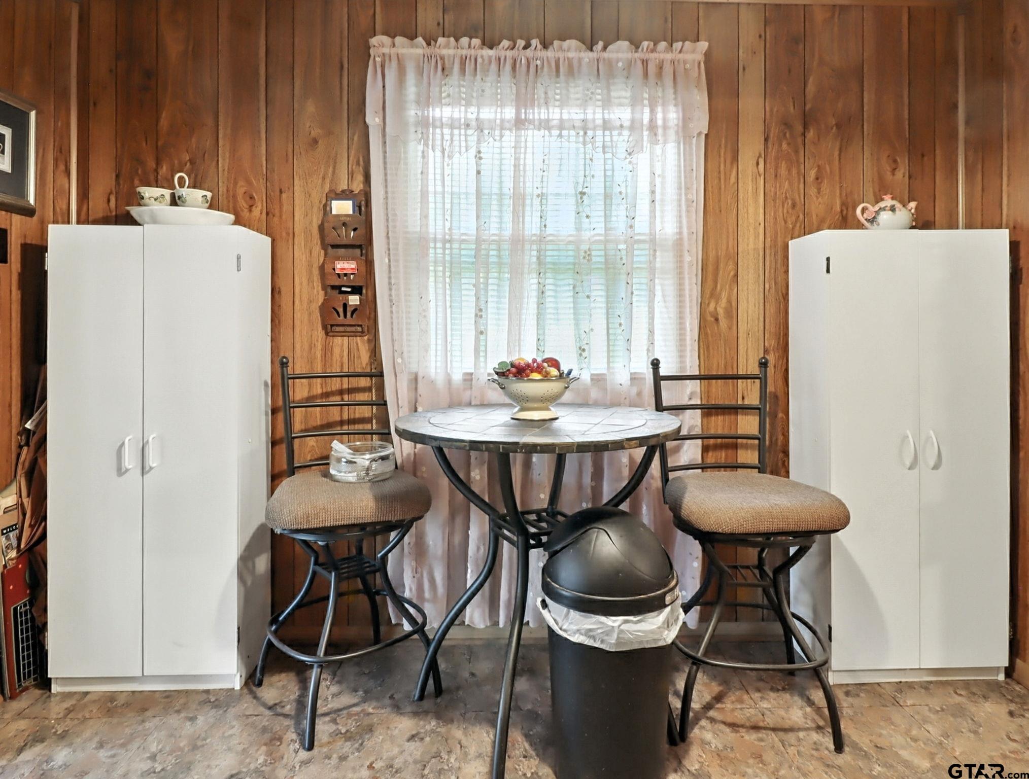402 Watson Road Gladewater, TX 75647 - Photo 10 of 32 a dining room with furniture and window