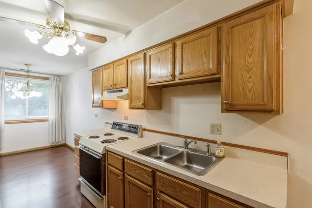 a kitchen with a stove a sink and a refrigerator
