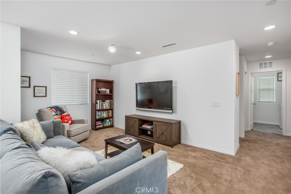 14019 Dandolo Lane Beaumont, CA 92223 - Photo 16 of 34 a living room with furniture and a flat screen tv