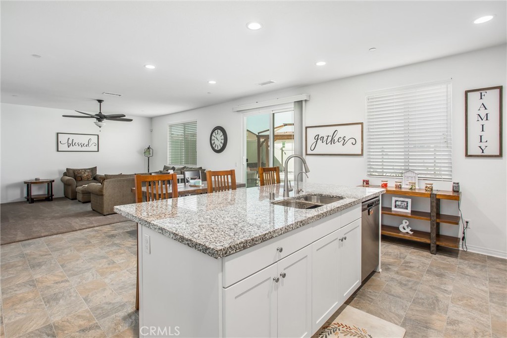 14019 Dandolo Lane Beaumont, CA 92223 - Photo 10 of 34 a kitchen with stainless steel appliances granite countertop a sink and a white cabinets