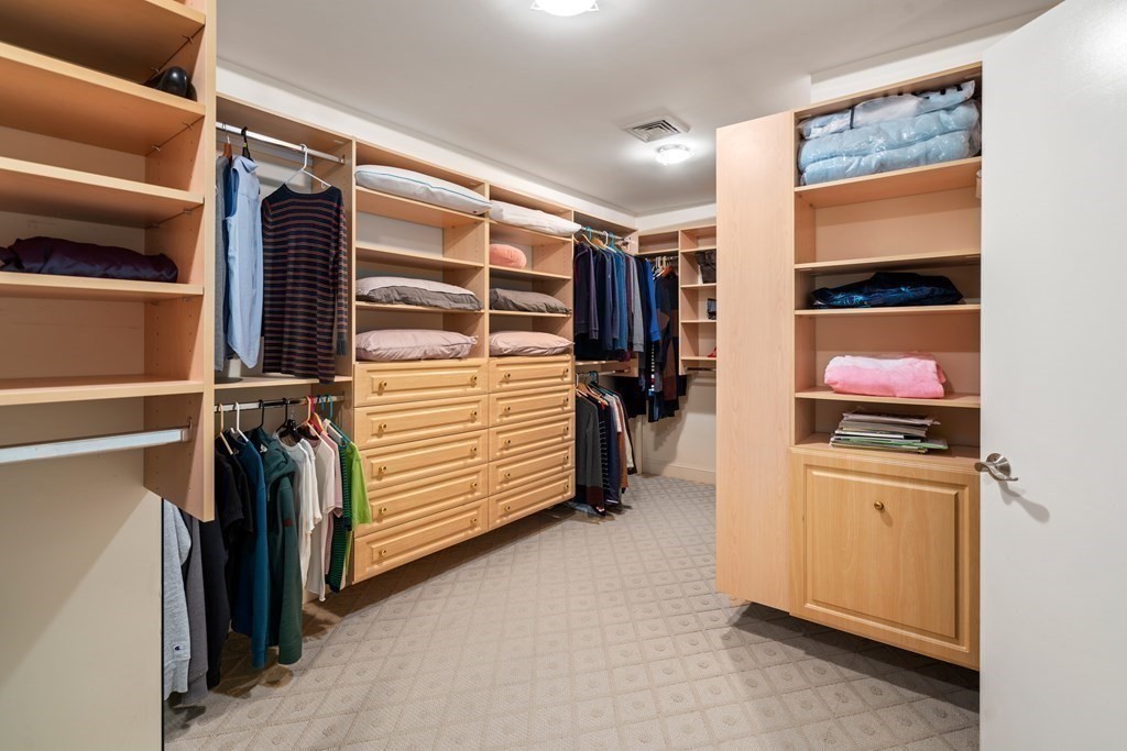 71 Sevland Road Newton, MA 02459 - Photo 13 of 28 a view of walk in closet with clothes and shoes