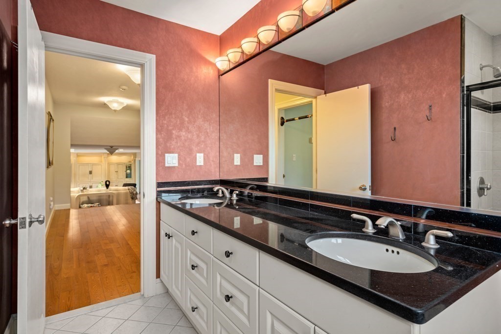 71 Sevland Road Newton, MA 02459 - Photo 17 of 28 a bathroom with a granite countertop sink and a mirror