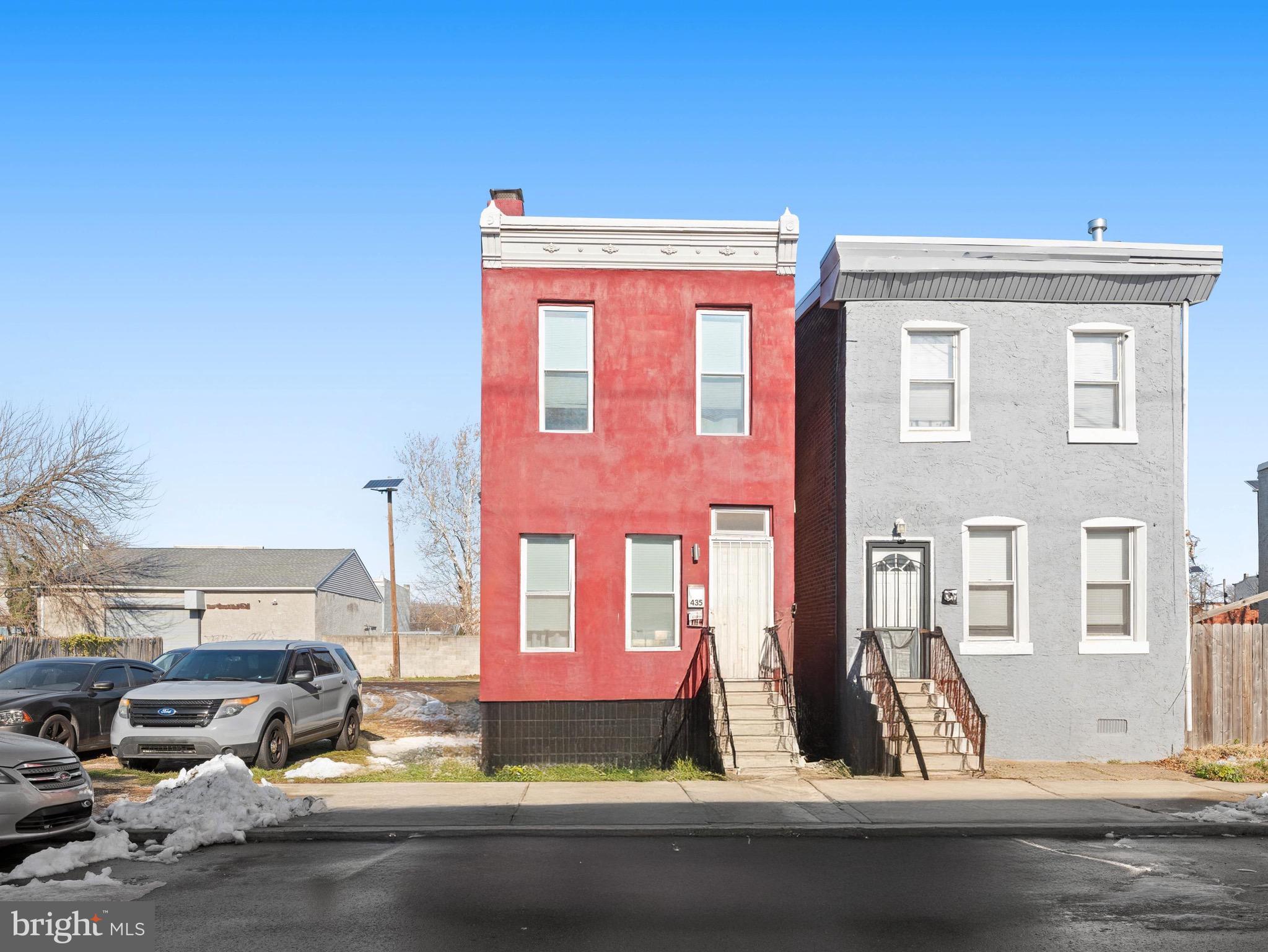 a front view of a house with car parked