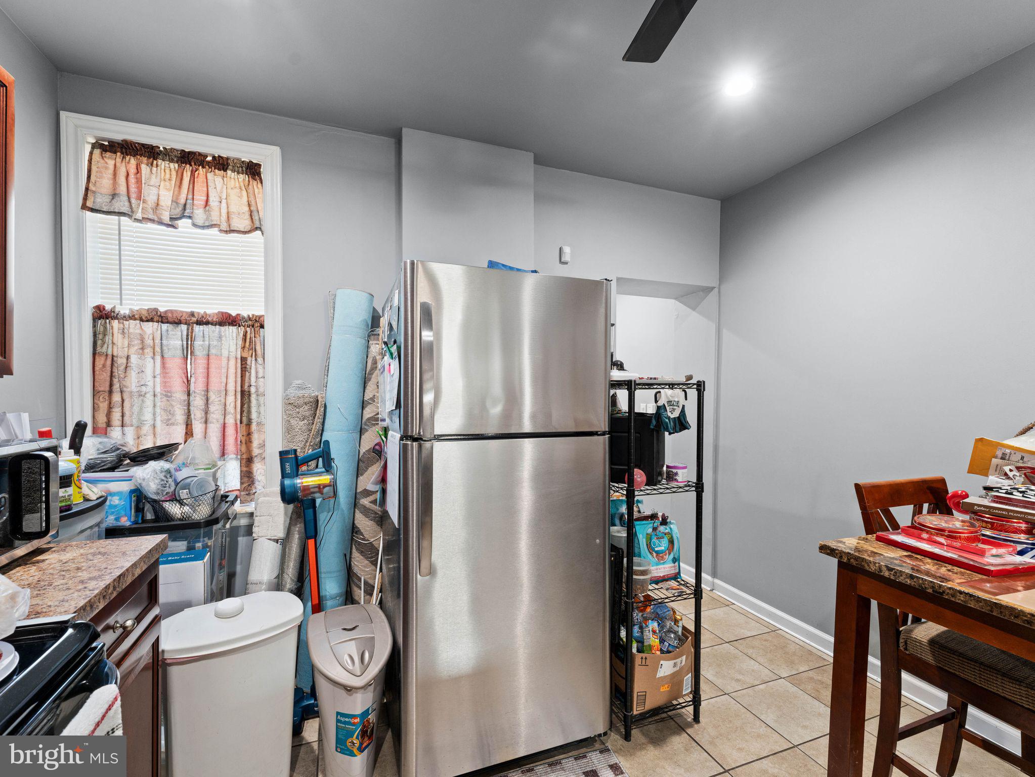 435 Mechanic Street Camden, NJ 08104 - Photo 8 of 16 a kitchen with a refrigerator and a stove top open