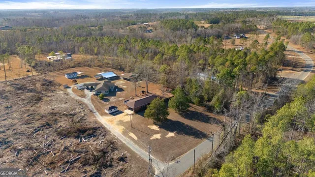 an aerial view of a house with a yard