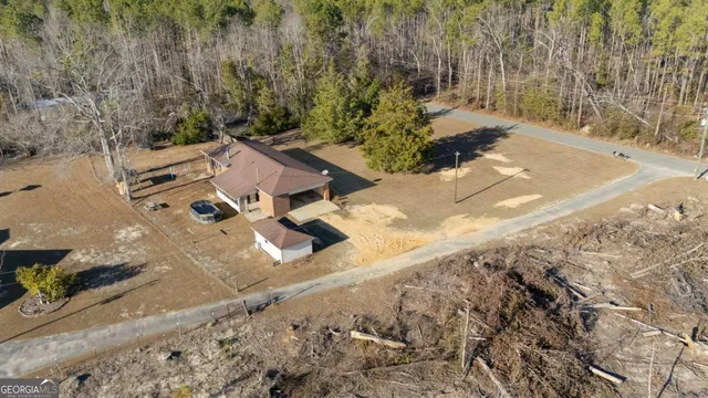 an aerial view of a house with a yard
