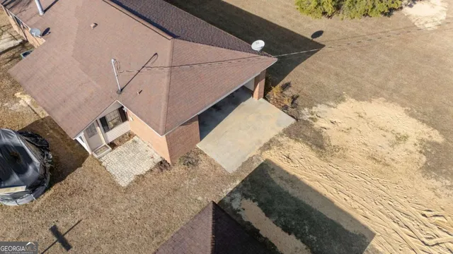 a view of roof and covered with wooden fence