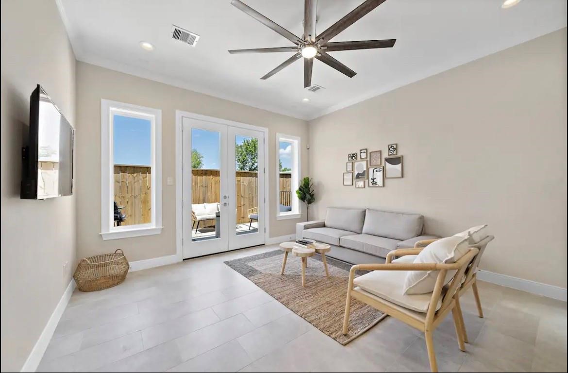 a living room with furniture and large windows
