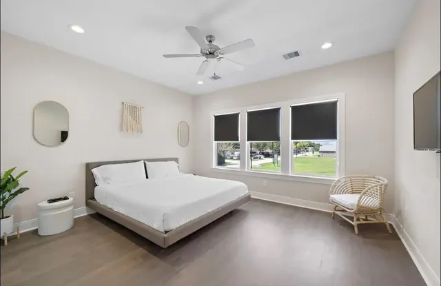 a bedroom with a bed and a large window