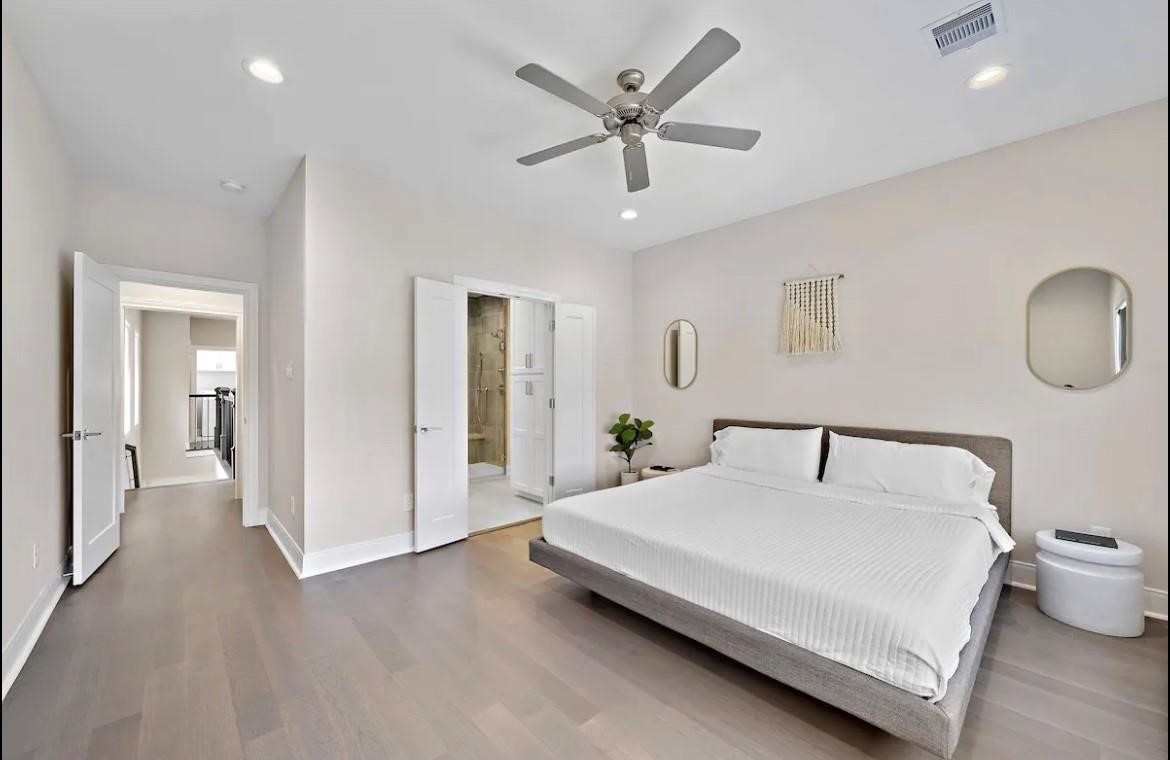 3703 Bolin Road, Unit B Houston, TX 77092 - Photo 12 of 22 a bedroom with a large bed and a chandelier