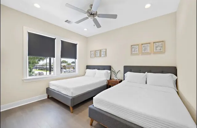 a spacious bedroom with two beds and a window