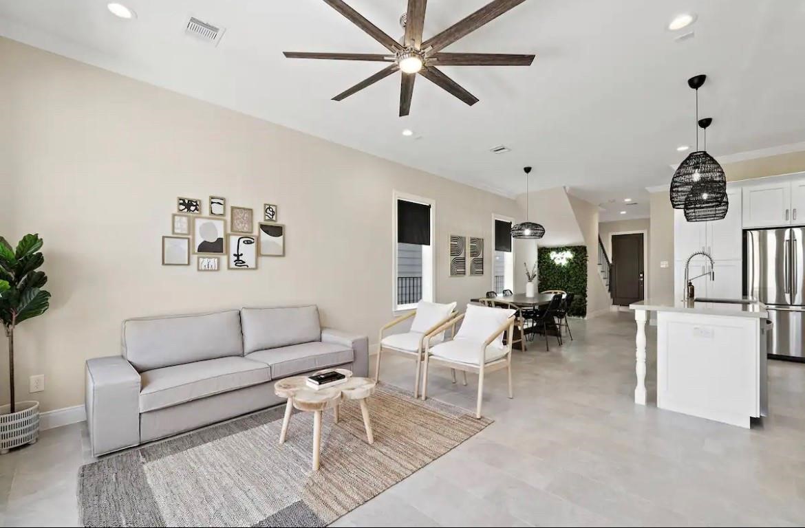 3703 Bolin Road, Unit B Houston, TX 77092 - Photo 2 of 22 a living room with furniture a rug and a chandelier
