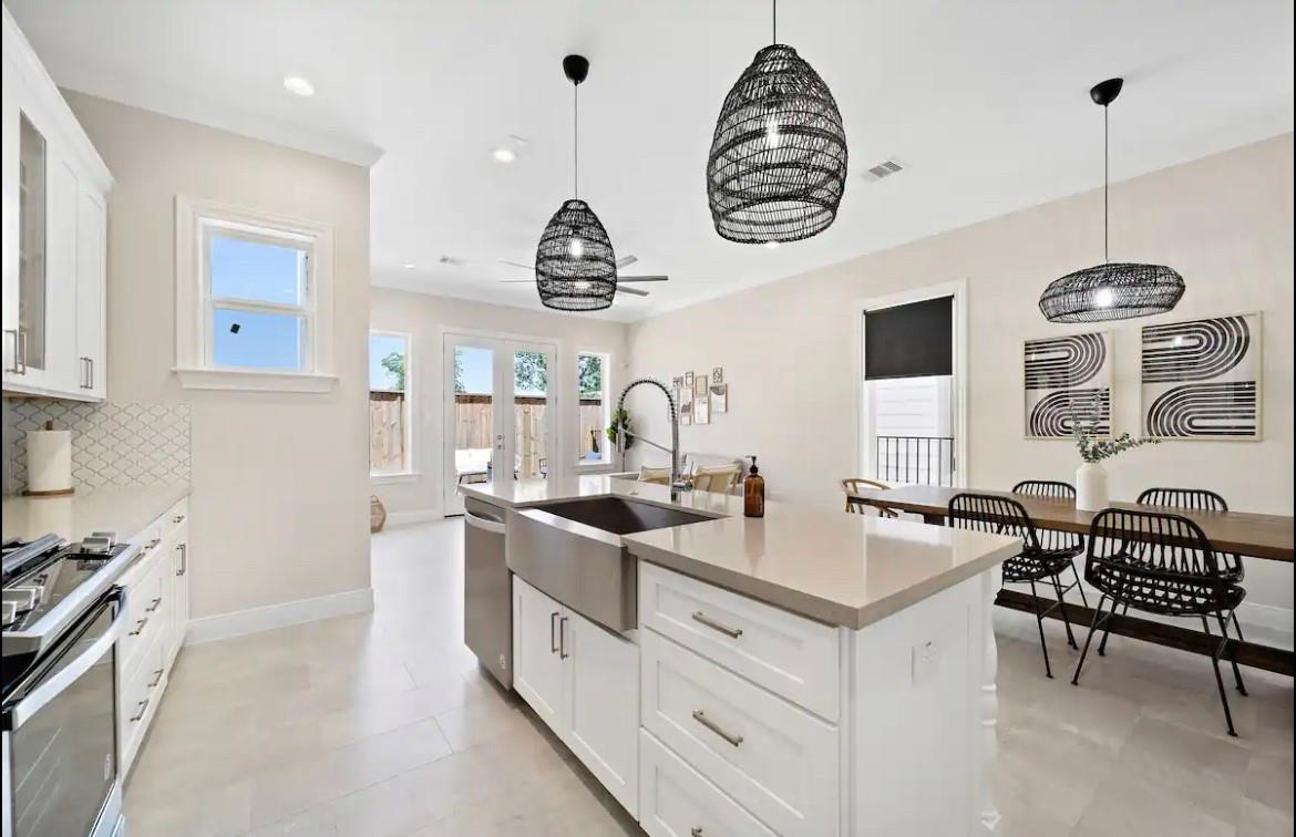 3703 Bolin Road, Unit B Houston, TX 77092 - Photo 4 of 22 a kitchen with cabinets a sink and a stove