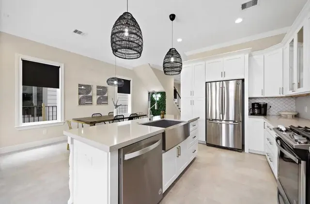 a kitchen with a refrigerator and a sink