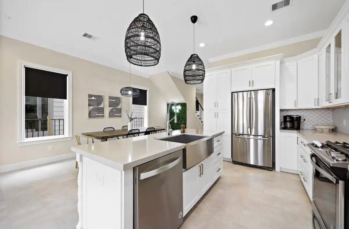 3703 Bolin Road, Unit B Houston, TX 77092 - Photo 5 of 22 a kitchen with a refrigerator and a sink