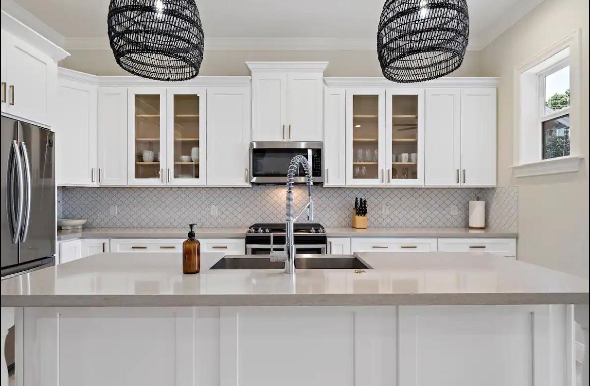 3703 Bolin Road, Unit B Houston, TX 77092 - Photo 6 of 22 a kitchen with stainless steel appliances a stove a sink and a microwave