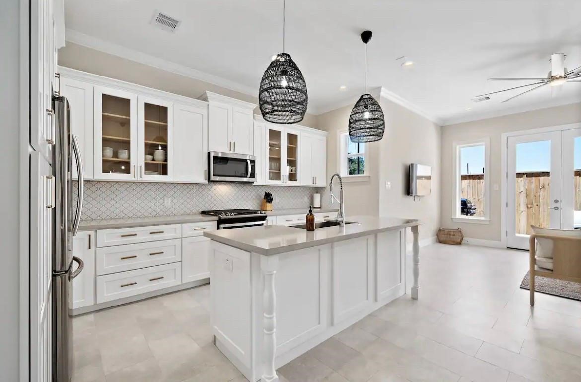 3703 Bolin Road, Unit B Houston, TX 77092 - Photo 7 of 22 a kitchen with stainless steel appliances granite countertop a stove a sink and a chandelier