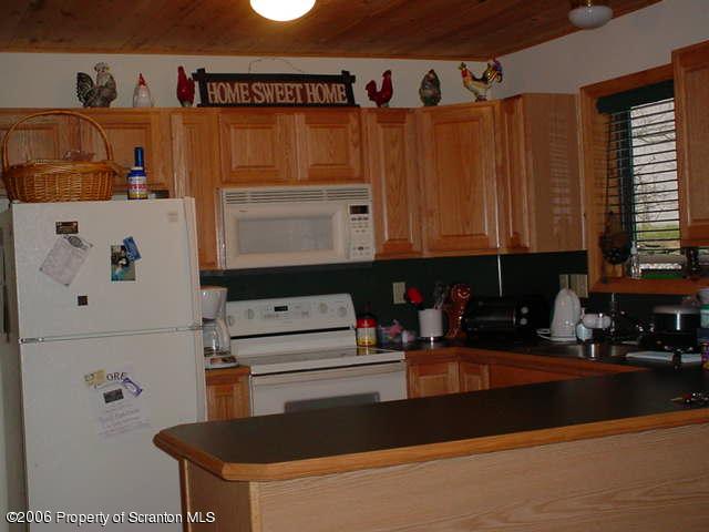 2338 Brookfield Road Lake Ariel, PA 18436 - Photo 5 of 9 a kitchen with stainless steel appliances granite countertop a refrigerator and a stove