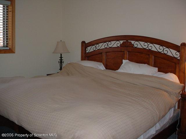 2338 Brookfield Road Lake Ariel, PA 18436 - Photo 7 of 9 a bedroom with a bed and a mirror