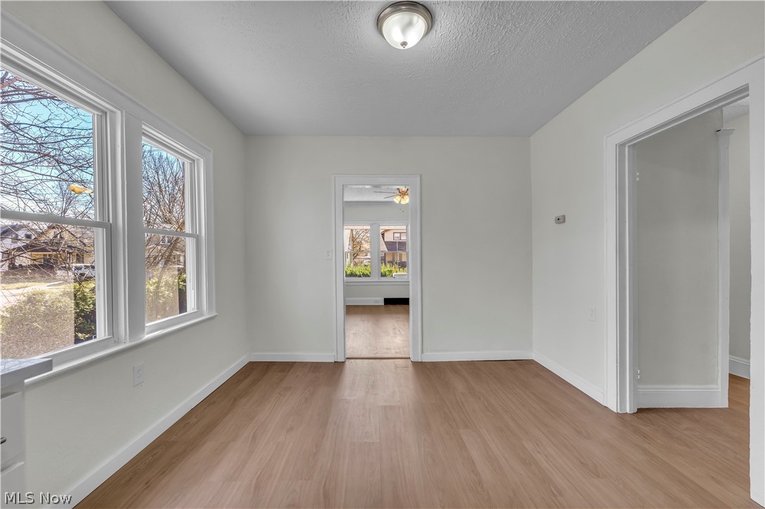 12905 Watterson Avenue Cleveland, OH 44105 - Photo 11 of 30 Spare room with a textured ceiling, light wood finished floors, and a ceiling fan