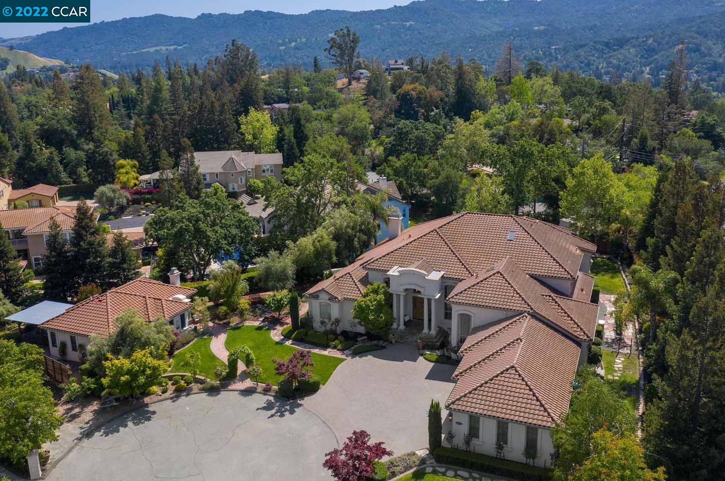 an aerial view of houses with a yard