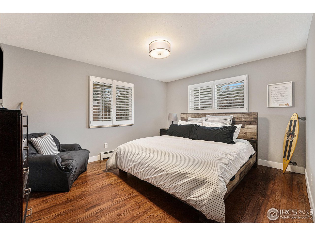 13700 Crabapple Road Golden, CO 80401 - Photo 17 of 39 a bedroom with a bed and wooden floor