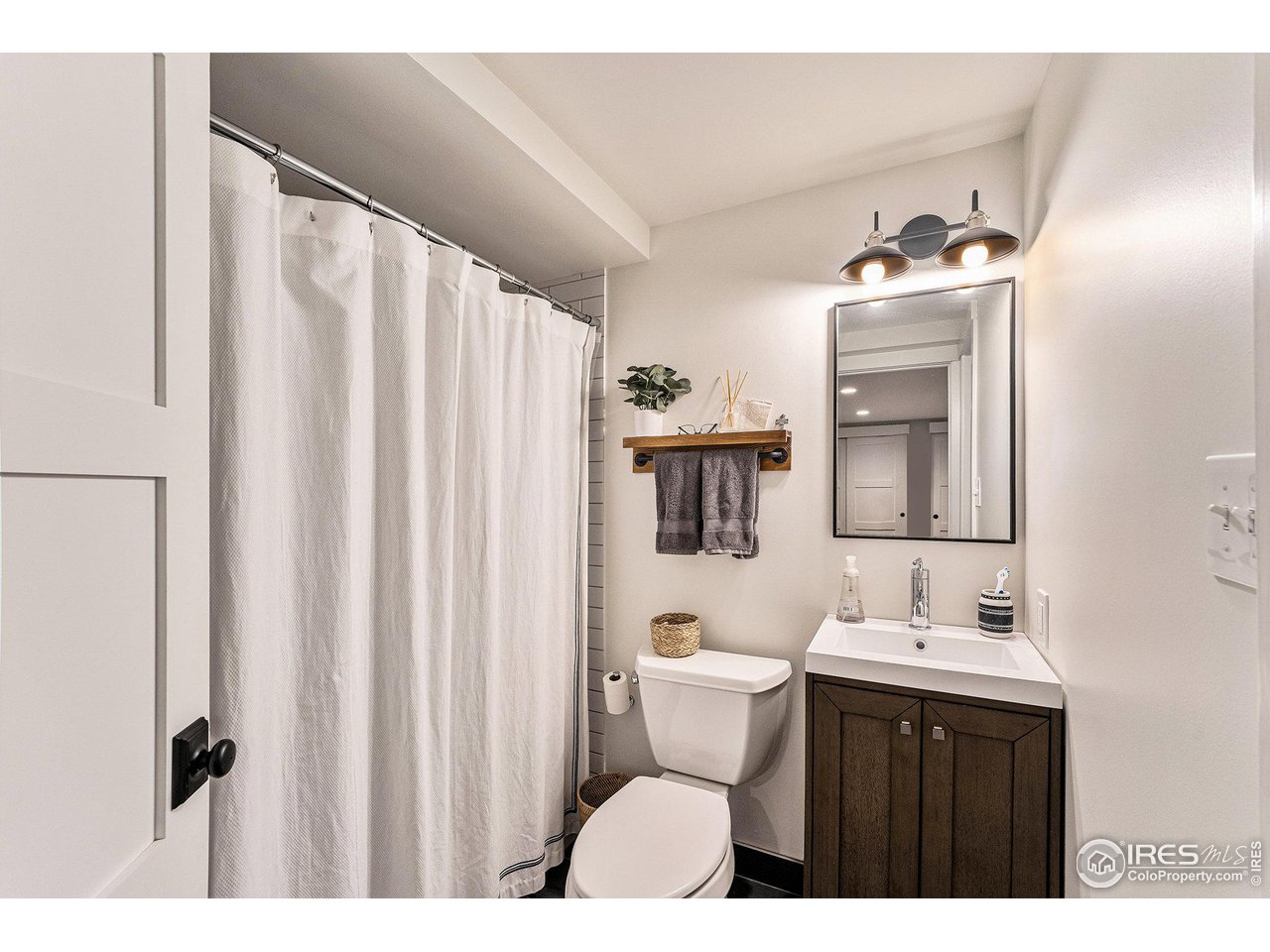 13700 Crabapple Road Golden, CO 80401 - Photo 26 of 39 a bathroom with a sink vanity mirror and toilet