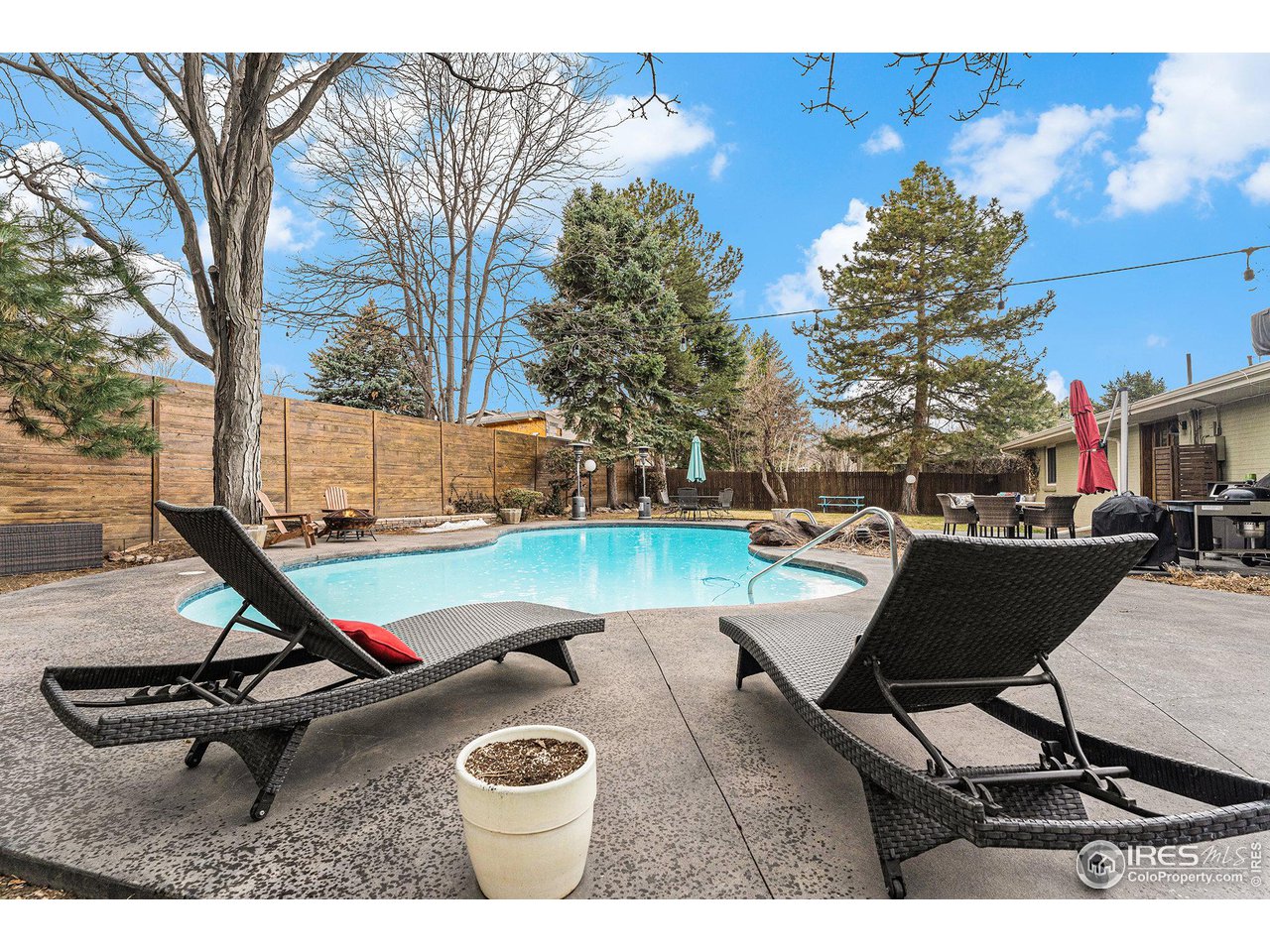 13700 Crabapple Road Golden, CO 80401 - Photo 34 of 39 a view of a swimming pool with chair and tables