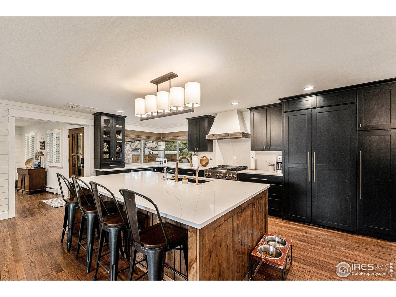 13700 Crabapple Road Golden, CO 80401 - Photo 9 of 39 a kitchen with refrigerator and chairs