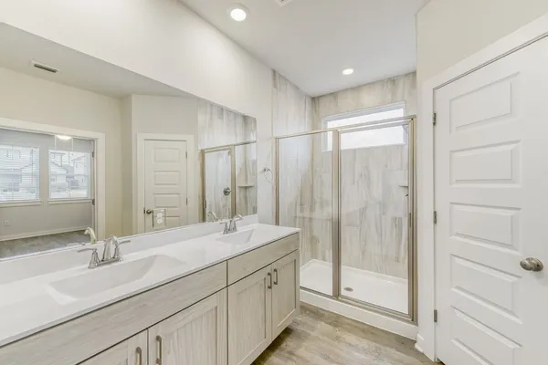 a bathroom with double sink and a mirror