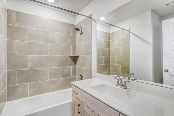 a bathroom with a sink shower and a mirror