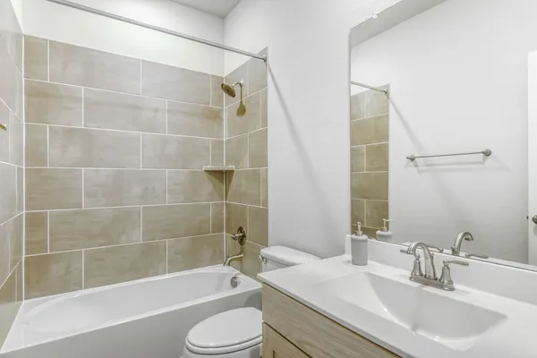 a bathroom with a sink mirror toilet and bathtub