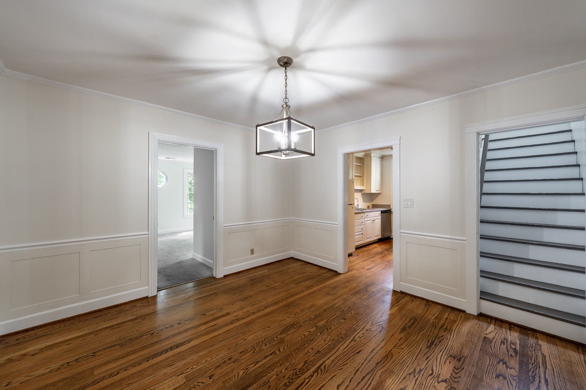 3508 Robin Road Nashville, TN 37204 - Photo 14 of 32 an empty room with wooden floor staircase and windows