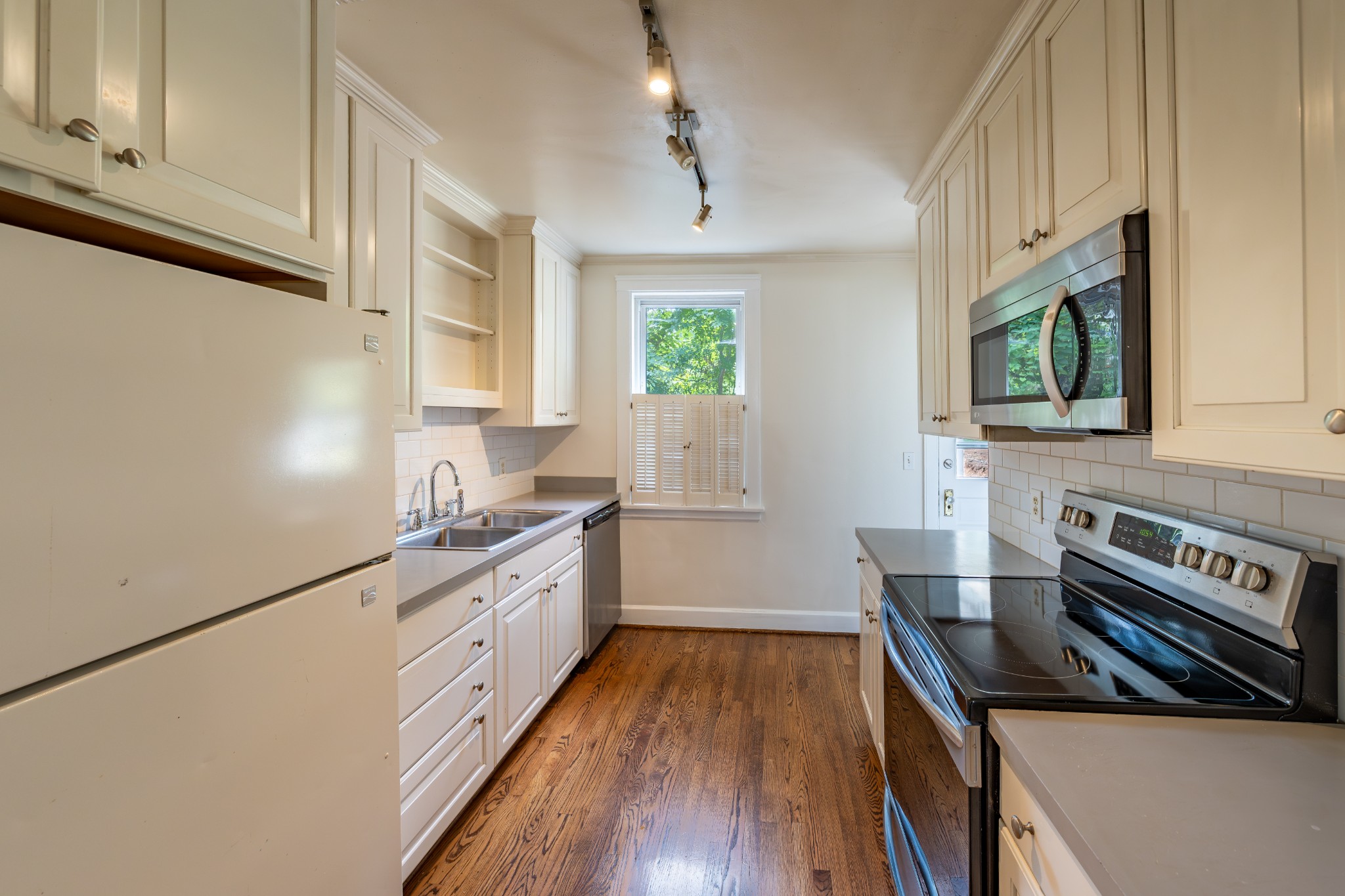 3508 Robin Road Nashville, TN 37204 - Photo 15 of 32 a kitchen with wooden floor a stove and a microwave