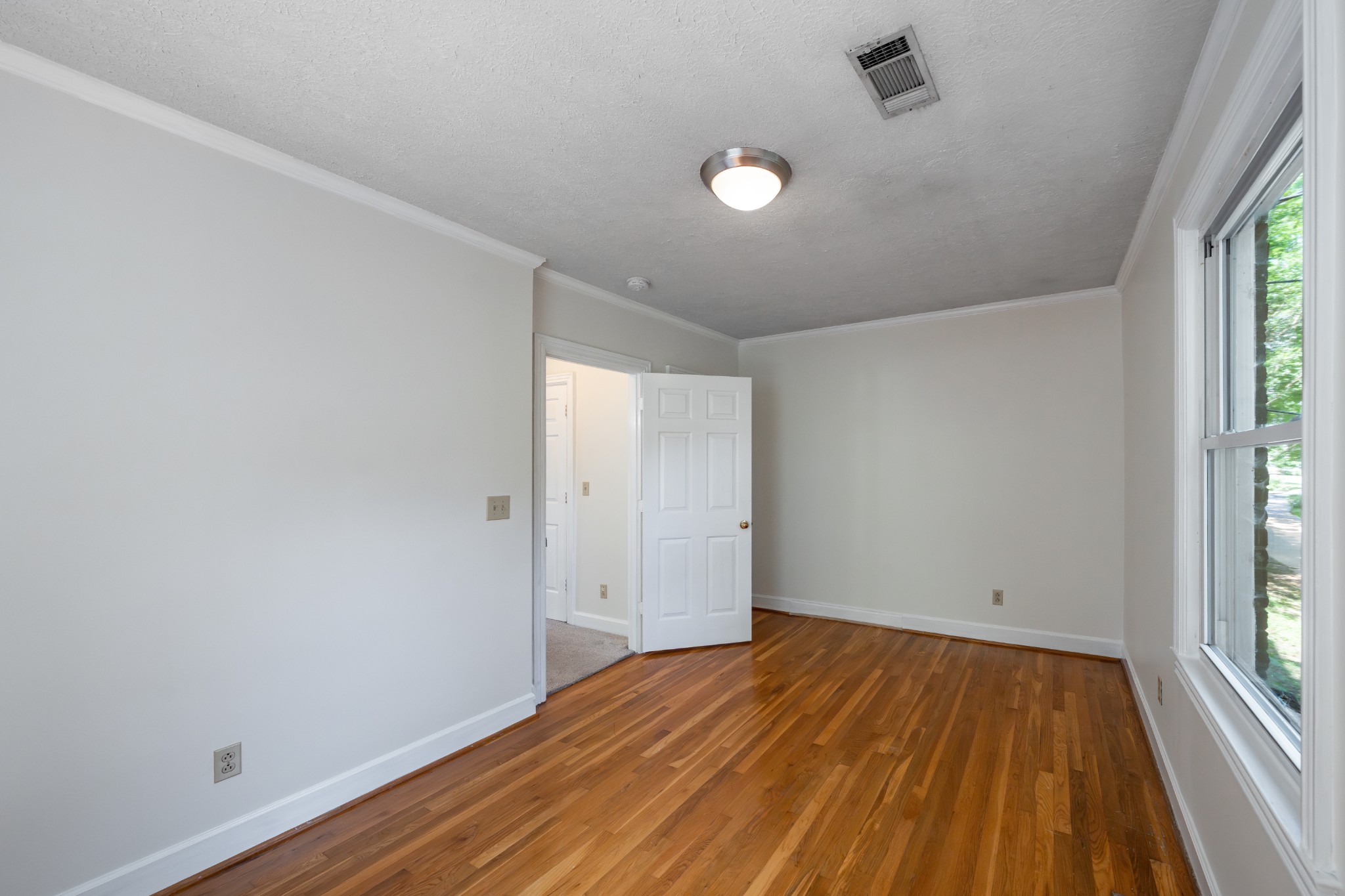 3508 Robin Road Nashville, TN 37204 - Photo 22 of 32 an empty room with wooden floor and windows