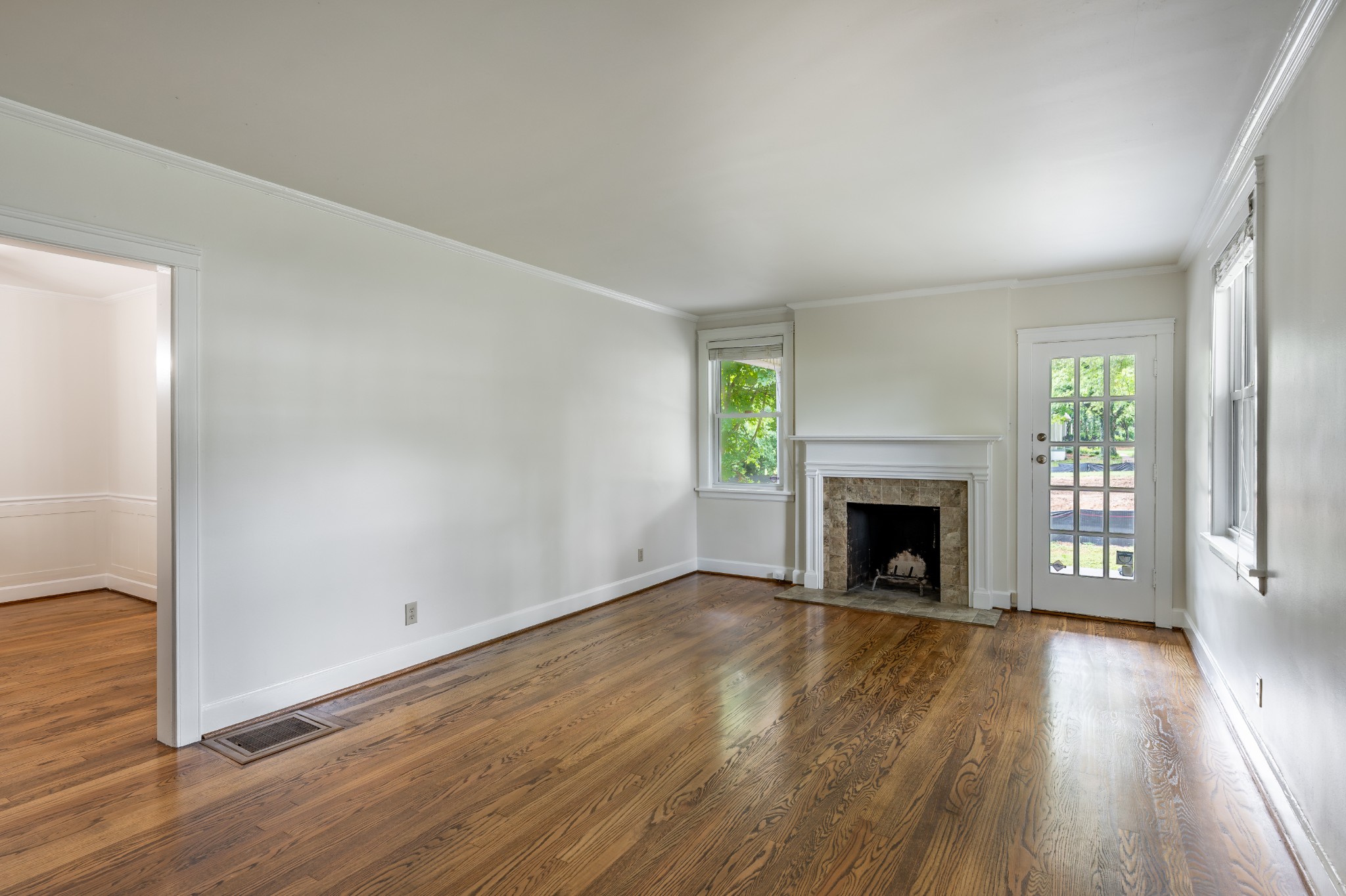3508 Robin Road Nashville, TN 37204 - Photo 7 of 32 an empty room with wooden floor fireplace and windows