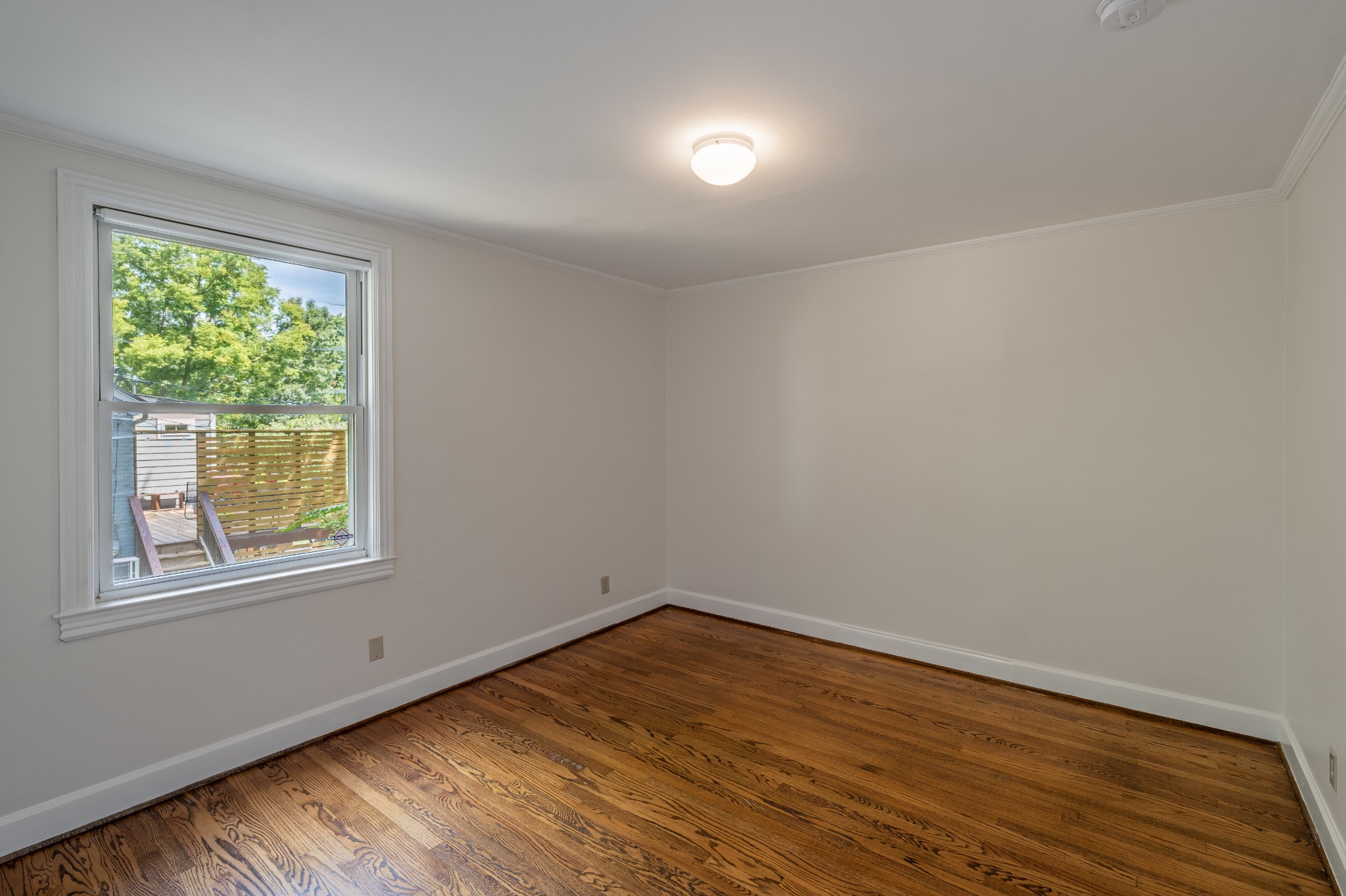 3508 Robin Road Nashville, TN 37204 - Photo 10 of 32 an empty room with wooden floor and windows