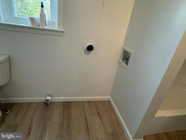 a view of a room with wooden floor and window