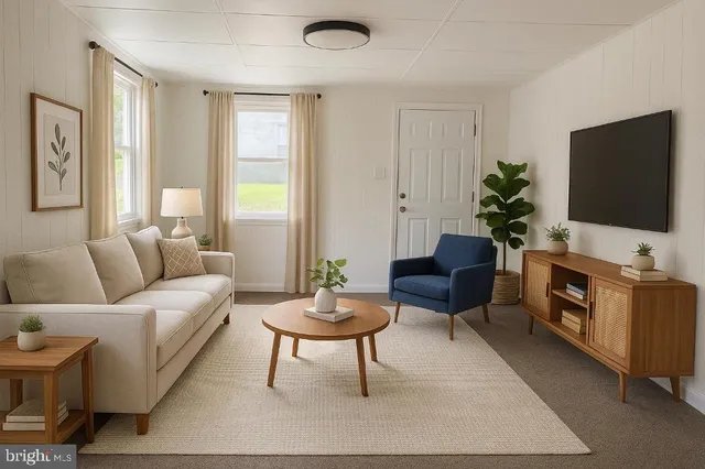 a living room with furniture a flat screen tv and a window