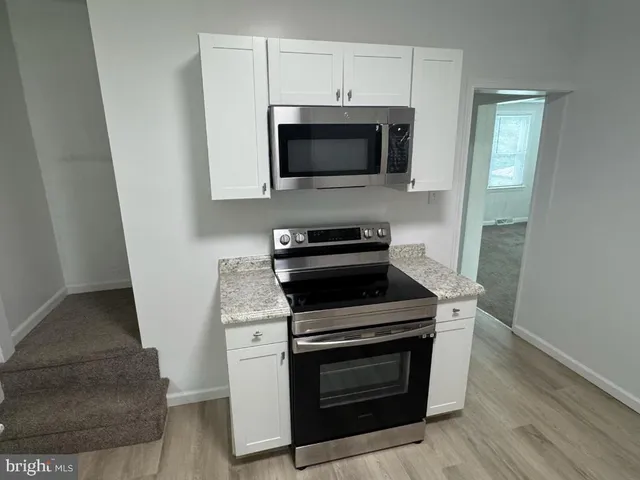 a kitchen with a stove and a microwave