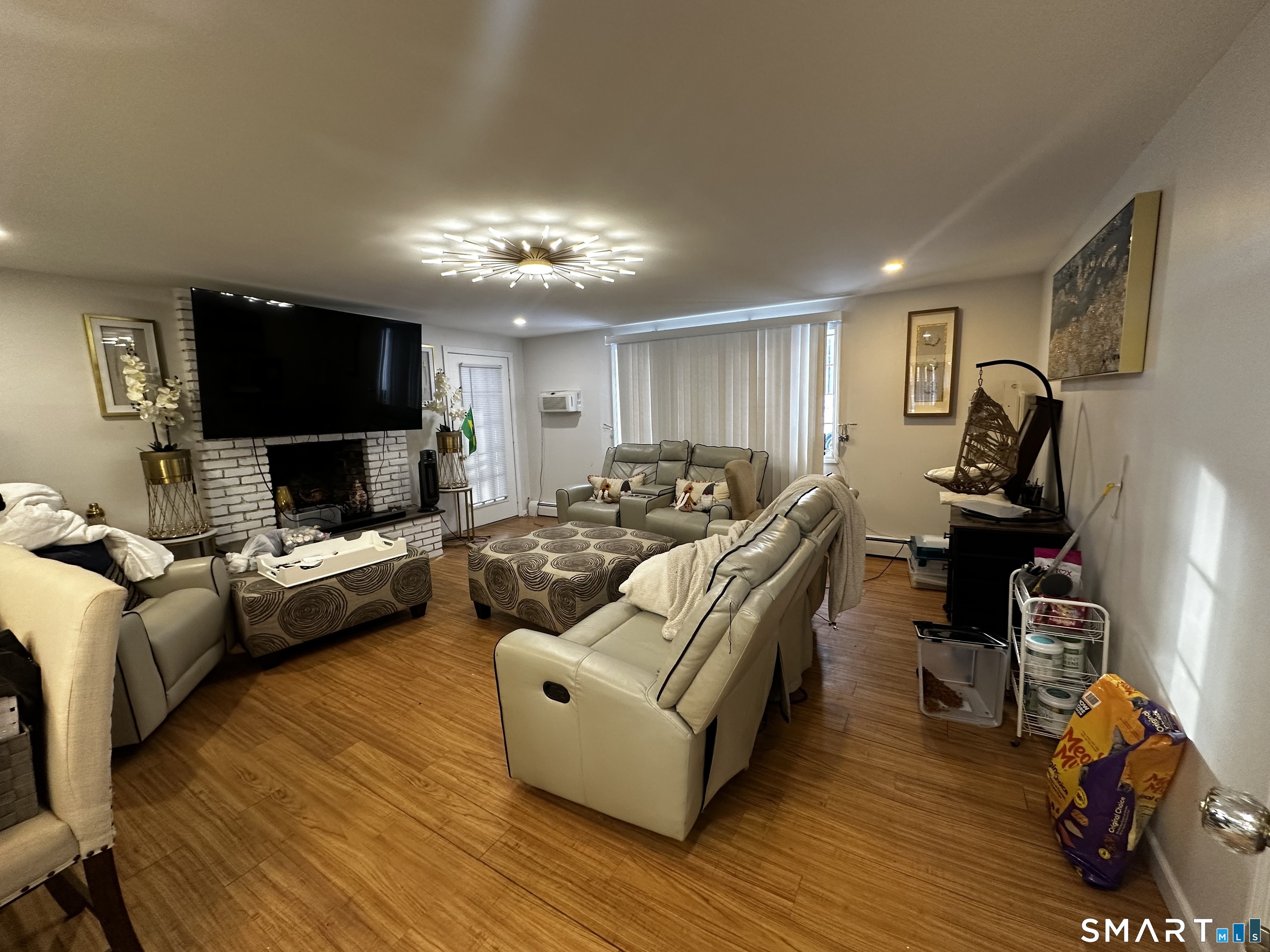 249 Wheeler Road Monroe, CT 06468 - Photo 14 of 39 a living room with furniture a flat screen tv and a fireplace