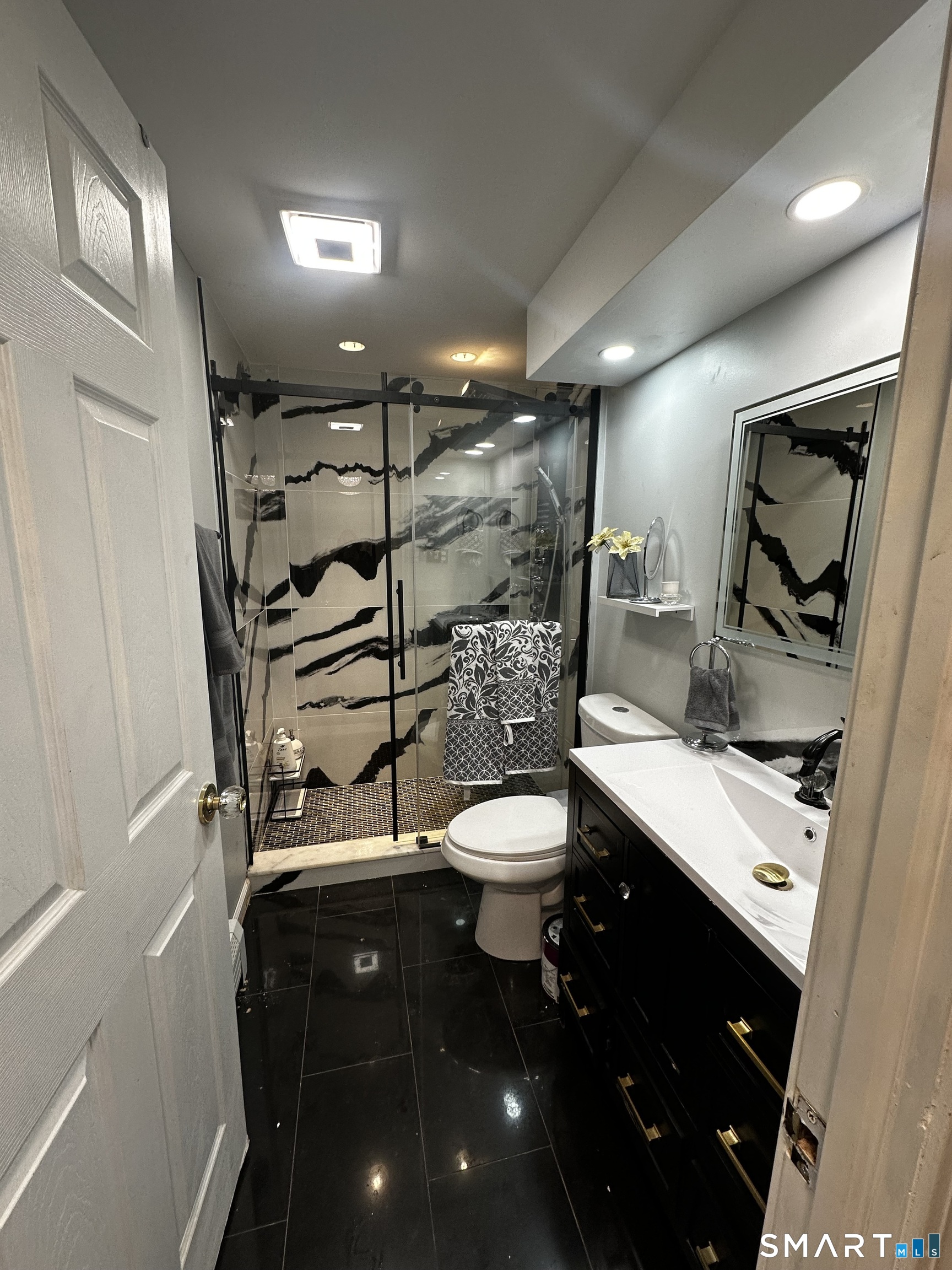 249 Wheeler Road Monroe, CT 06468 - Photo 20 of 39 a bathroom with a toilet a sink and mirror