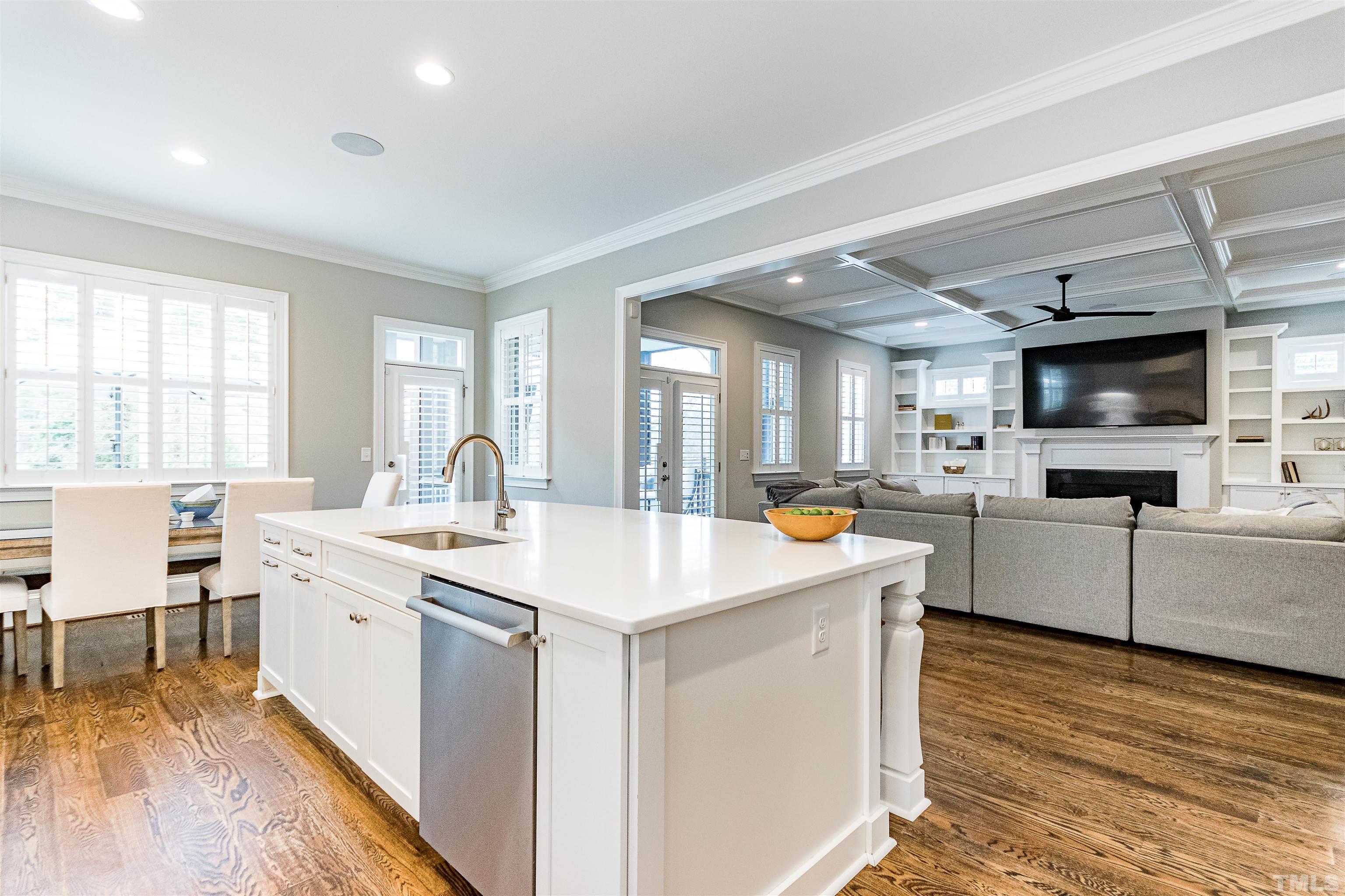 641 Cranbrook Road Raleigh, NC 27609 - Photo 14 of 39 a large white kitchen with cabinets a sink a window and stainless steel appliances