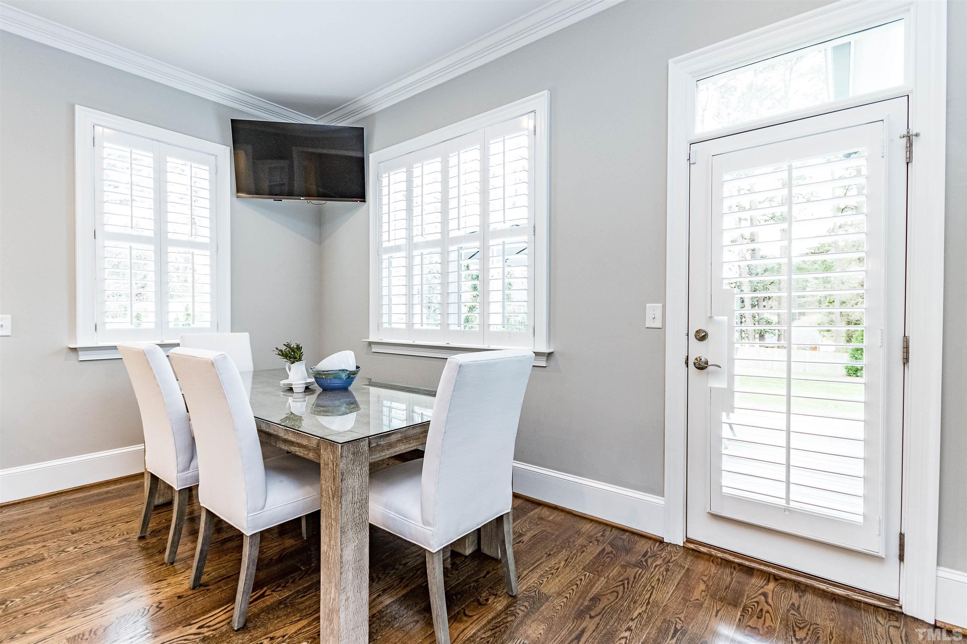 641 Cranbrook Road Raleigh, NC 27609 - Photo 15 of 39 a view of a dining room with furniture and wooden floor