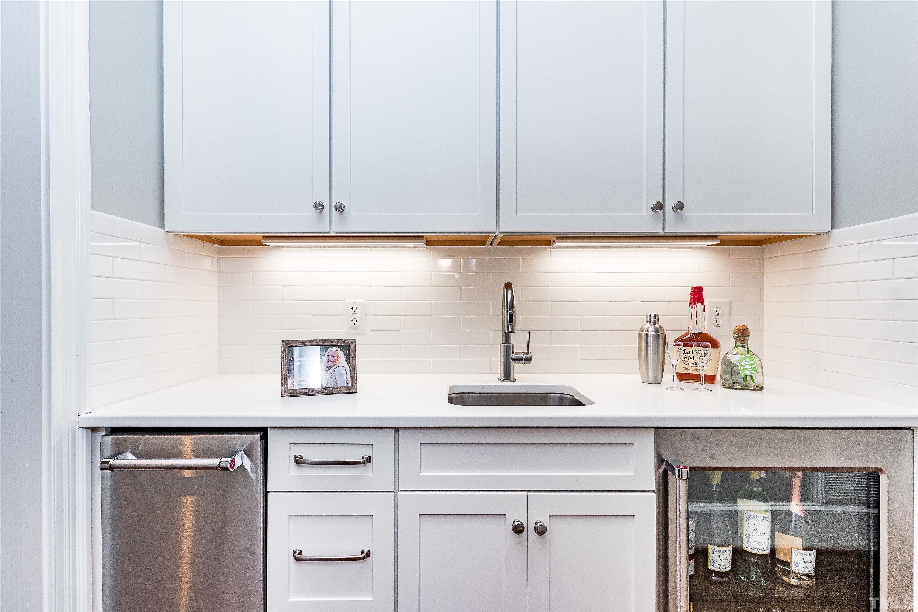 641 Cranbrook Road Raleigh, NC 27609 - Photo 16 of 39 a kitchen with white cabinets and a sink