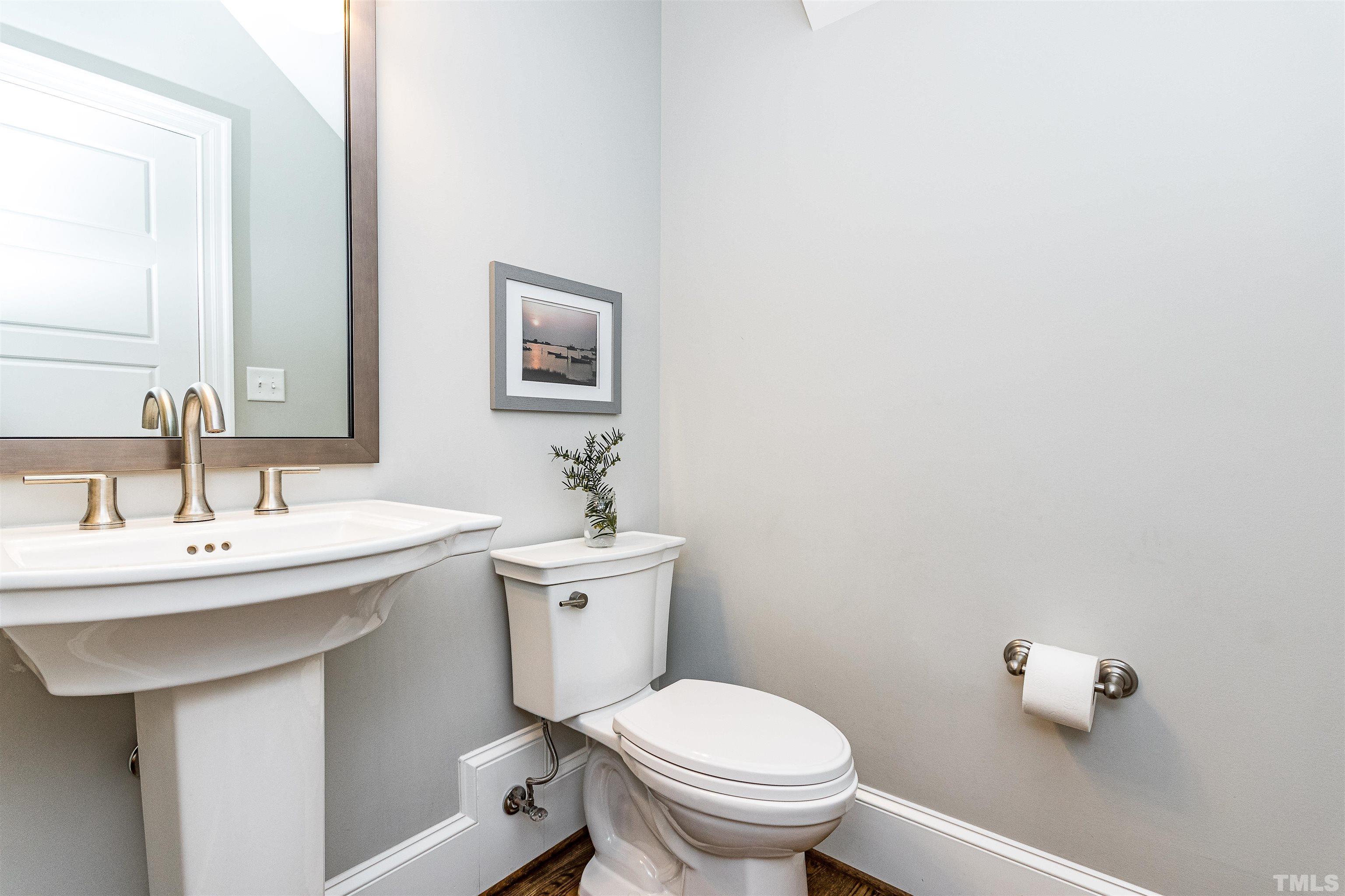 641 Cranbrook Road Raleigh, NC 27609 - Photo 18 of 39 a bathroom with a toilet sink and mirror