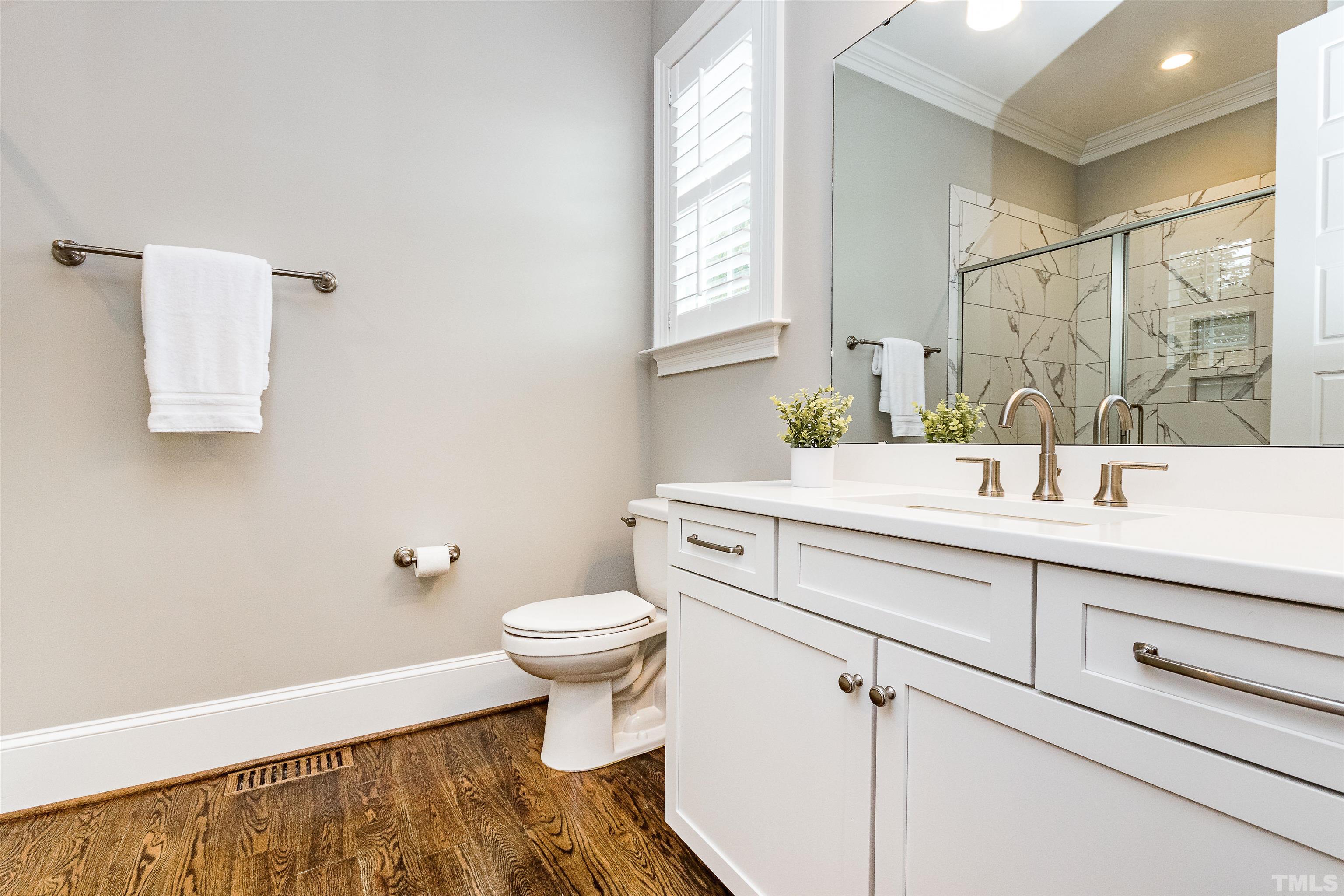 641 Cranbrook Road Raleigh, NC 27609 - Photo 20 of 39 a bathroom with a sink toilet a mirror and vanity