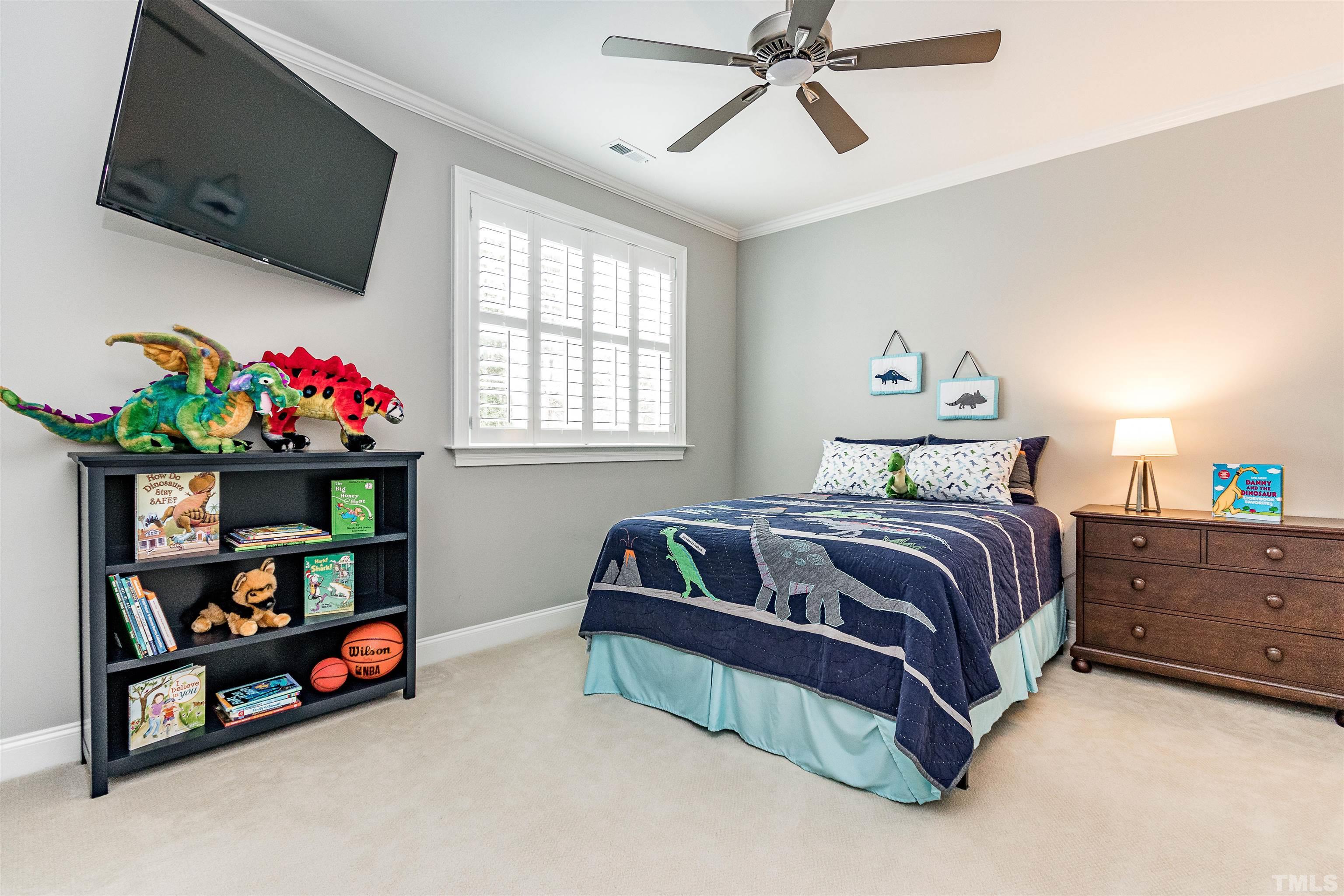 641 Cranbrook Road Raleigh, NC 27609 - Photo 25 of 39 a bedroom with a bed a flat screen tv and a window